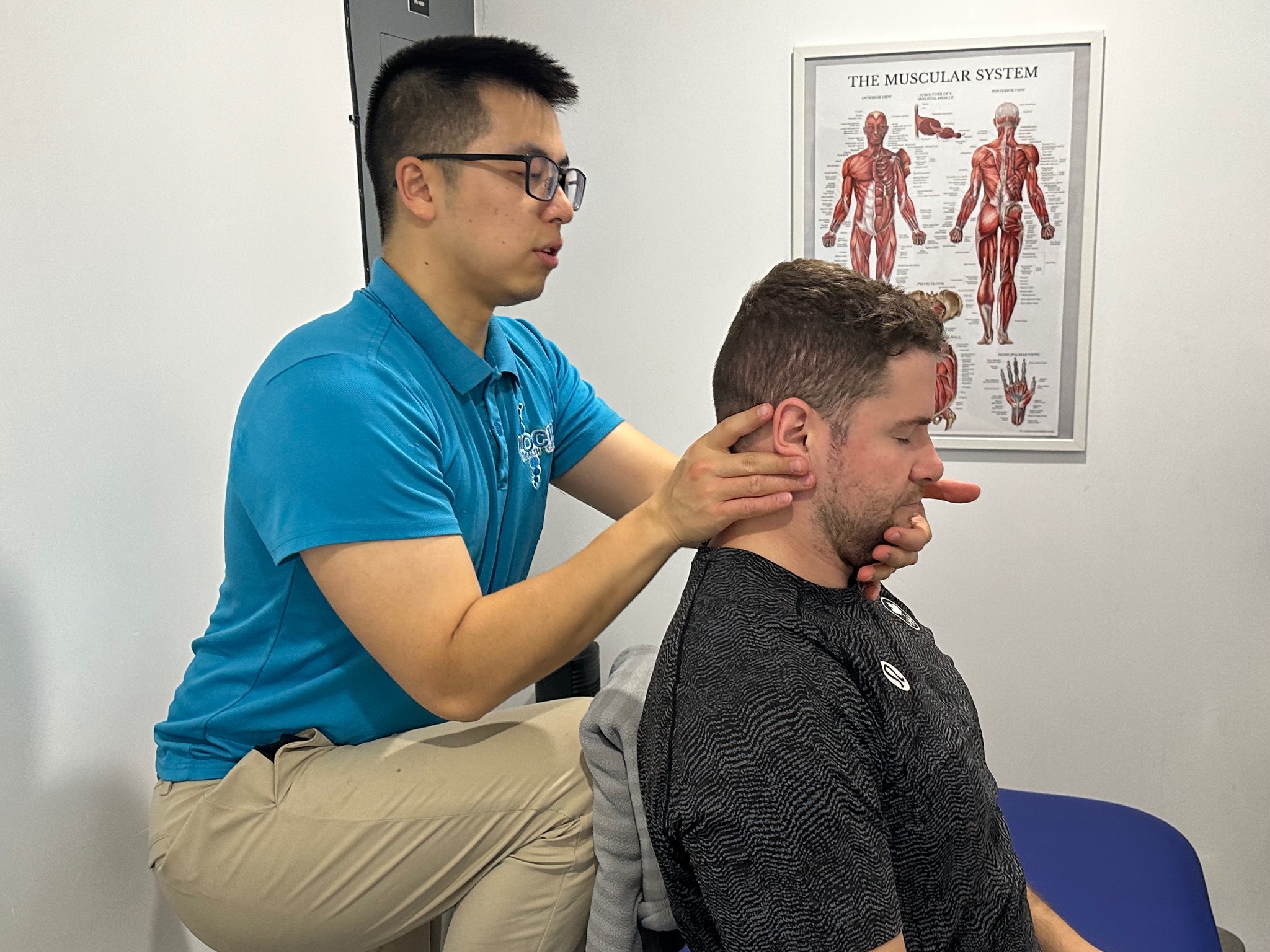 Chiropractor performing neck adjustment at Locus Health Centre Vancouver