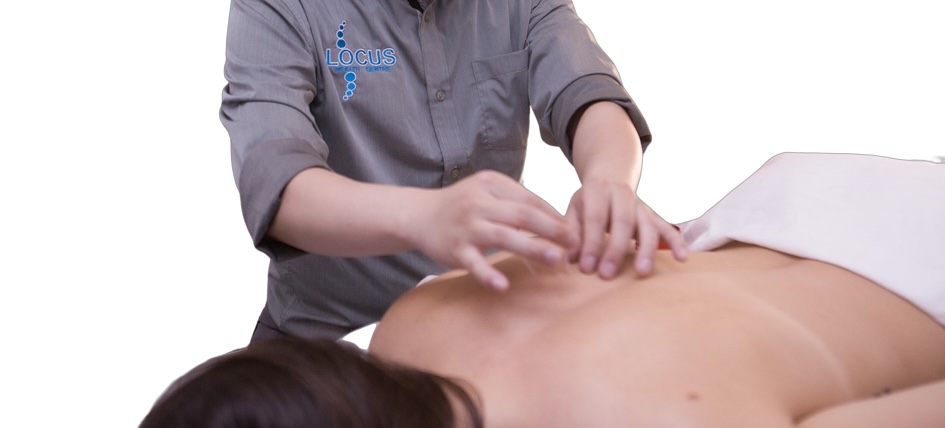 Locus Health practitioner performing acupuncture treatment on patient back